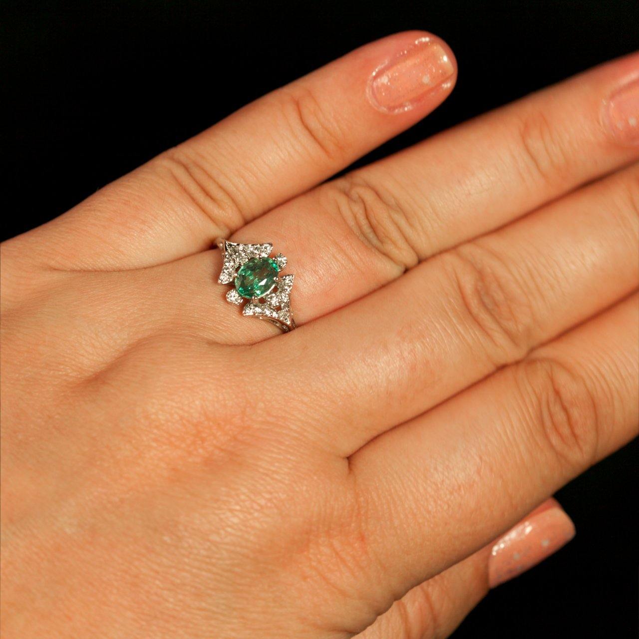 A woman's hand adorned with a 0.68ct alexandrite ring in 18k white gold