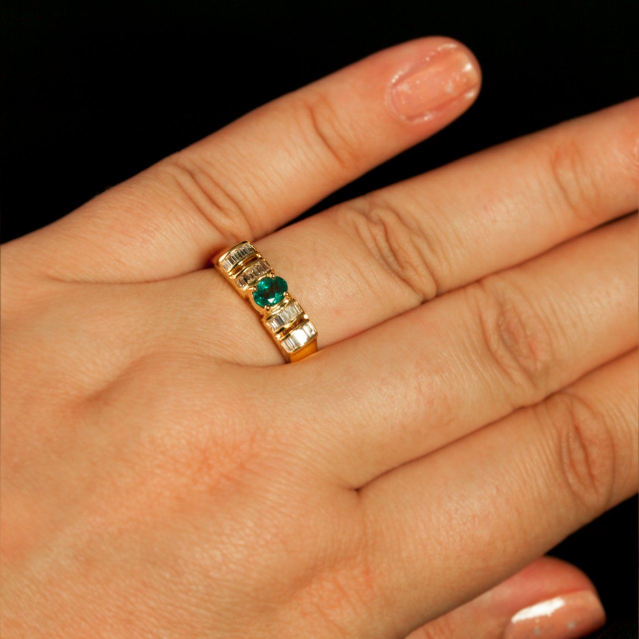 A woman's hand adorned with the 18k yellow gold ring with a 0.37ct natural alexandrite