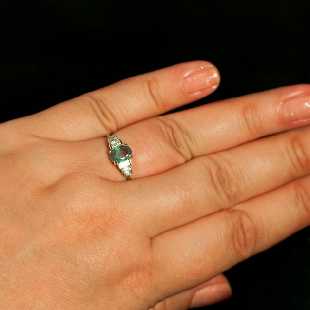 Woman's hand wearing an 18k white gold ring with a 0.71ct natural alexandrite